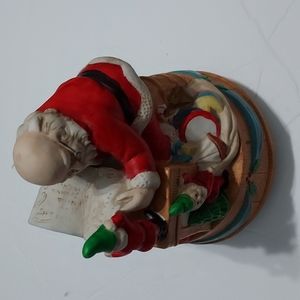 Santa checking his list Music Box "Here comes Santa Claus". 7 inches H x 5 inchW